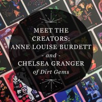 Designed graphic for RP Mystic blog post “Meet the Creators: Anne Louise Burdett and Chelsea Granger of Dirt Gems.” The title is set inside a semitransparent black circle over a photo of face-up cards from “Dirt Gems: Plant Oracle Deck and Guidebook.”